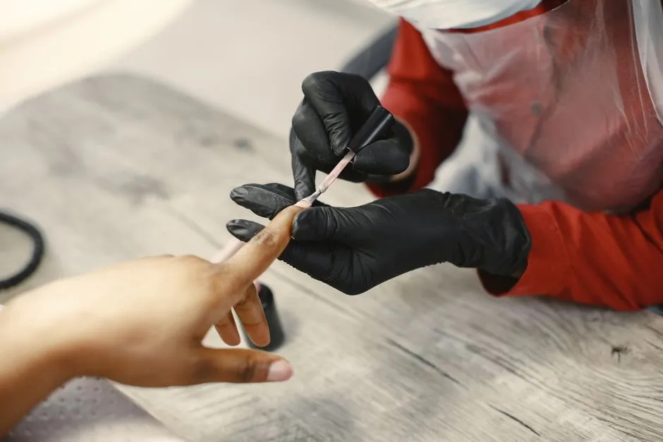 Close-up of a gel manicure being applied at a nail salon