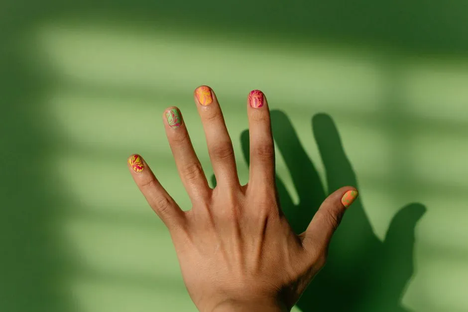 A close-up of hand-painted nail art on a manicured hand